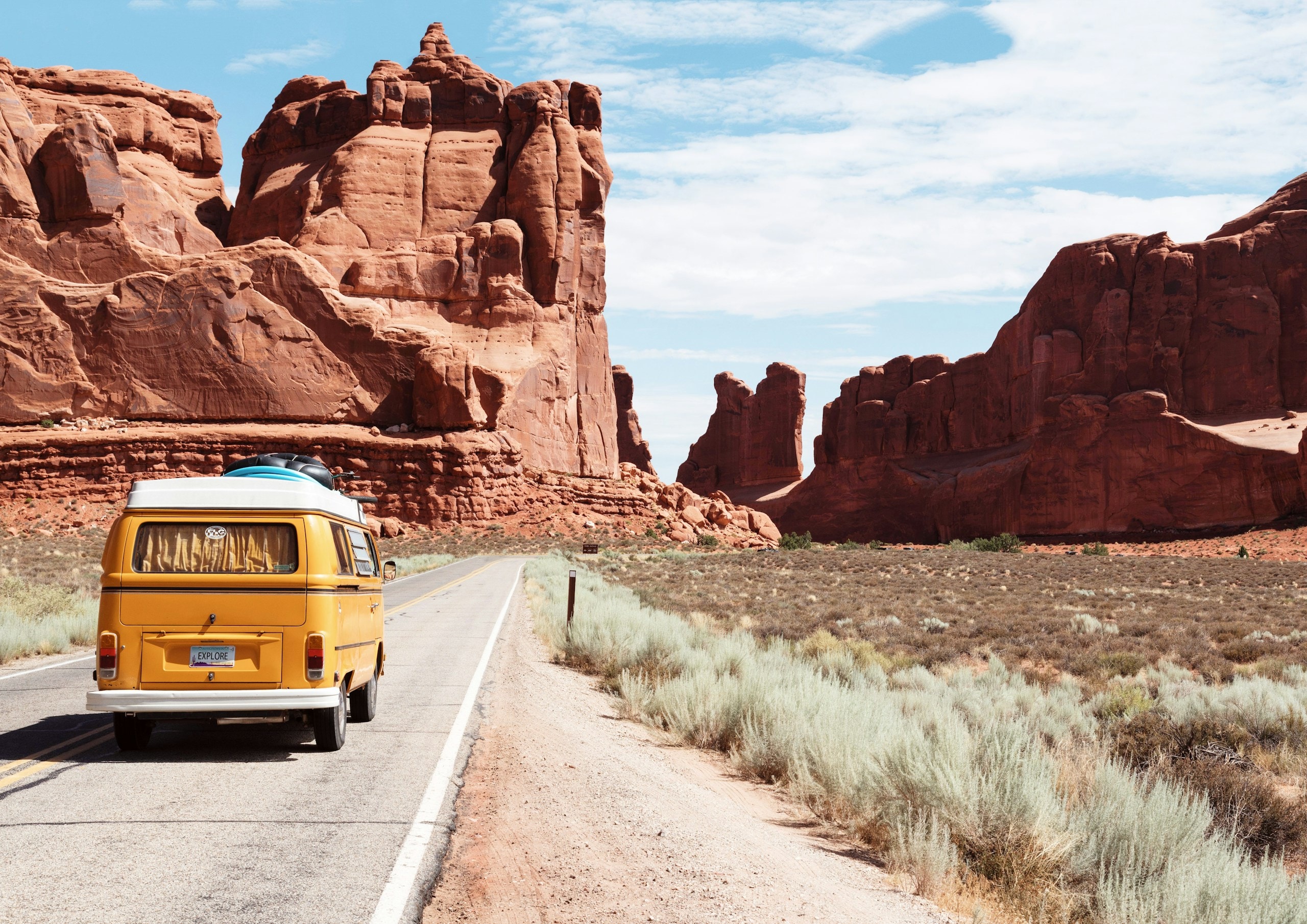 Car driving at sunset on an open road